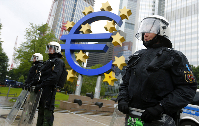 Riot police stand near the euro sign in front of the European Central Bank headquarters during an anti-capitalist "Blockupy" demonstration in Frankfurt